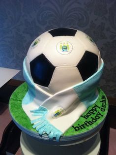 there is a cake that looks like a soccer ball on top of the cake,