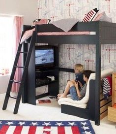 a young boy sitting on top of a bunk bed next to a flag rug in a bedroom