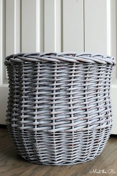 a wicker basket is sitting on the floor