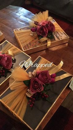 three boxes with flowers in them sitting on a table