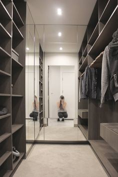 two women sitting on the floor in front of a walk - in closet