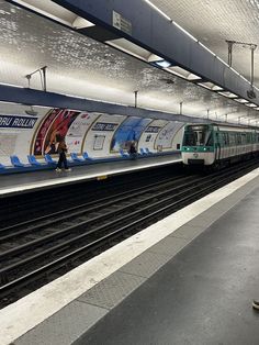 a subway train pulling up to the platform