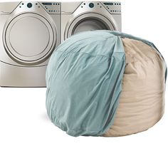 a laundry bag sitting next to a washer and dryer in front of it