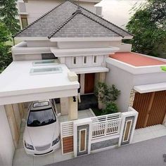 an aerial view of a house with a car parked in the driveway