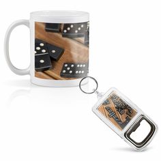 a white coffee mug sitting on top of a wooden table next to a metal keychain