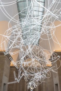 an artistic sculpture in the middle of a building with white lines all over it's surface