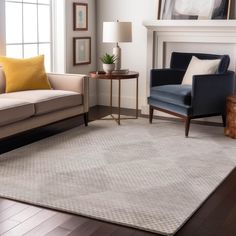 a living room with two couches and a chair next to a fire place in front of a fireplace