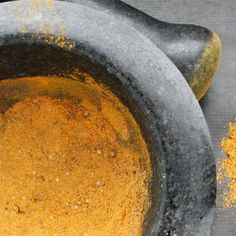 an old mortar bowl filled with yellow powder