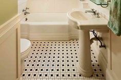 a bathroom with a sink, toilet and bathtub in it's center area