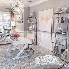 a living room filled with furniture and a chandelier