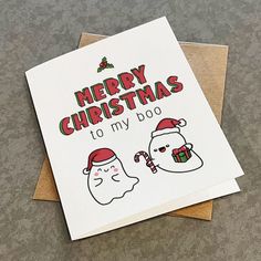 a christmas card that says merry christmas to my dog on the front, and an image of two ghostes in santa's hats