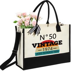 a white and black bag with pink roses in it