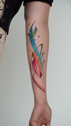 a woman's arm with an abstract tattoo design on the left side of her leg