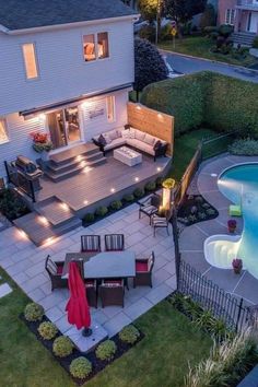 an aerial view of a house with a pool and outdoor furniture in the yard at night