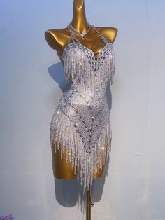 a mannequin dressed in silver with fringes on it