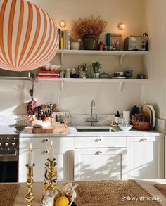 a kitchen filled with lots of counter top space and white cabinets next to a stove top oven