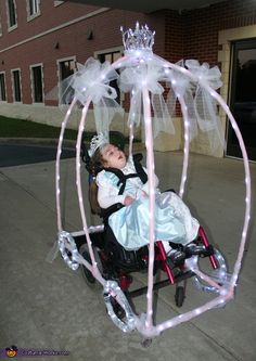 a small child in a carriage with lights on it