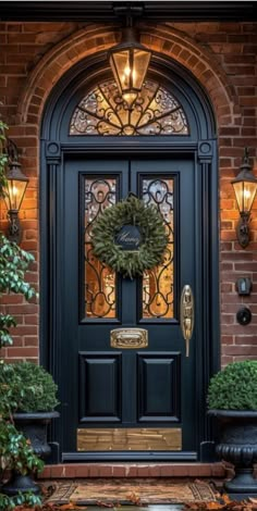 a black front door with a wreath on it