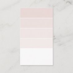 a white and pink color palette on a marble surface