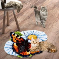 a cat standing on the floor next to a rug with an image of a butterfly