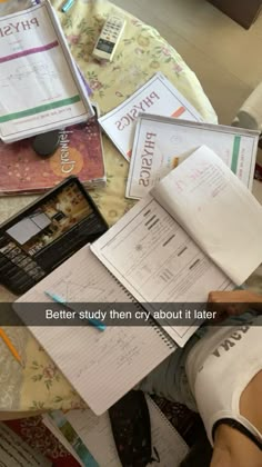 a person sitting at a table with books and papers on it