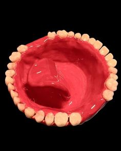 a red bowl with white rocks in it