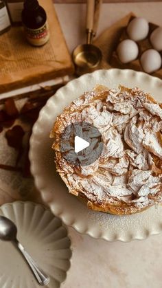 a pastry on a plate next to some eggs