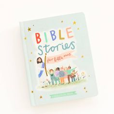 the bible stories for little ones book is laying on top of a white surface with stars