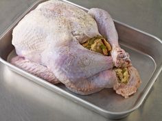 a whole chicken sitting in a pan on the counter