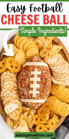 an easy football cheese ball with crackers and crackers on the side is shown