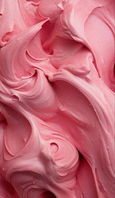 close up view of pink icing with swirls on it