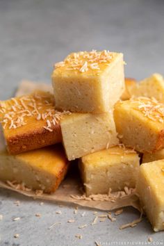 several pieces of cake sitting on top of a paper plate next to some sesame seeds