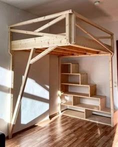 the loft bed is made from wood and has stairs leading up to it's top