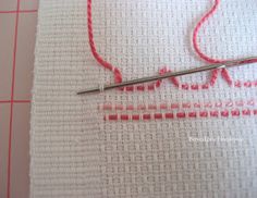 a close up of a piece of cloth with a needle