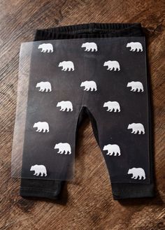 black and white bear print leggings on a wooden floor