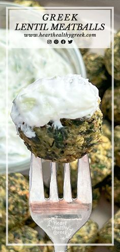 a close up of a fork with food on it and a bowl in the background