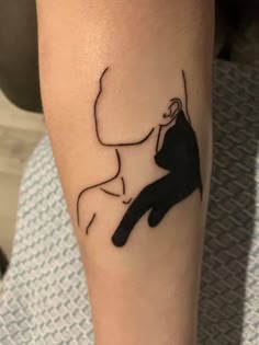 a person with a tattoo on their arm that has a drawing of a woman sitting down