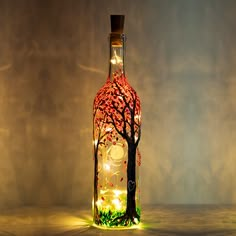 a lighted bottle with a tree in it