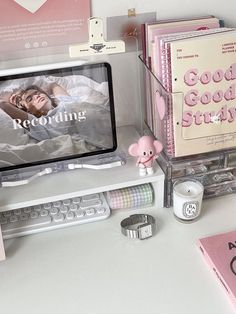 a desktop computer sitting on top of a desk next to books and other office supplies