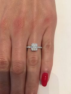 a woman's hand with a diamond ring on it