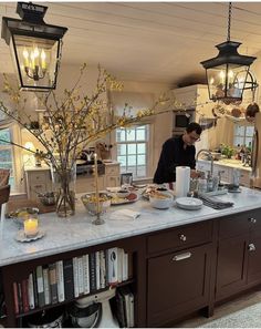 a man standing in the kitchen preparing food on top of a white marble countertop