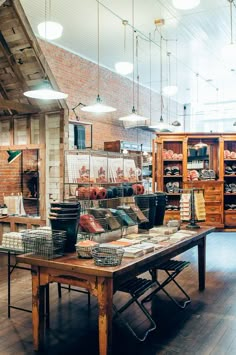 a room filled with lots of different types of furniture and lighting hanging from the ceiling