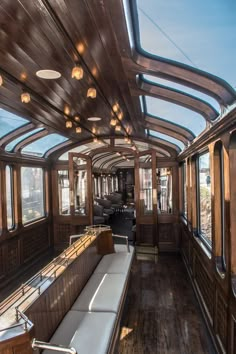 the inside of a train car with lots of windows and wood flooring on it