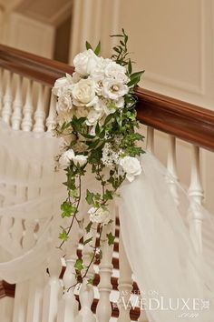 a bridal bouquet on the railing of a staircase