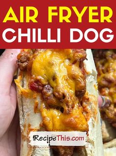 a person holding a hot dog in their hand with the words air fryer chili dog on it