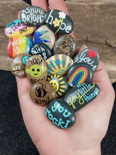 someone is holding some rocks with writing on them in their hand and it looks like they are made out of stones