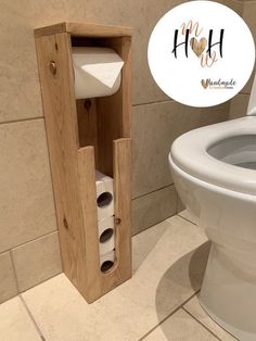 a wooden toilet paper dispenser next to a white toilet