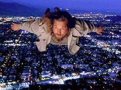 a man flying through the air over a city at night