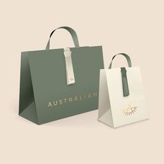 two green and white shopping bags with the word australian printed on them, sitting side by side