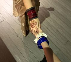 two people holding hands with henna tattoos on them